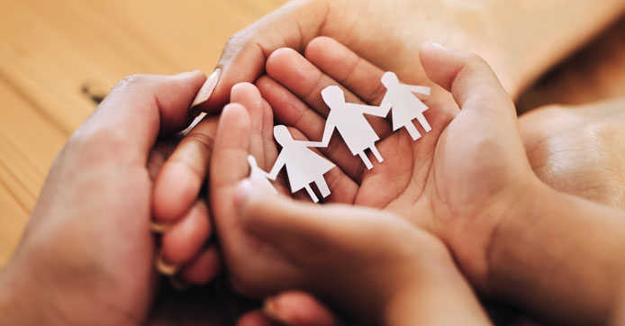 Image showing hands of a family and paper cutout