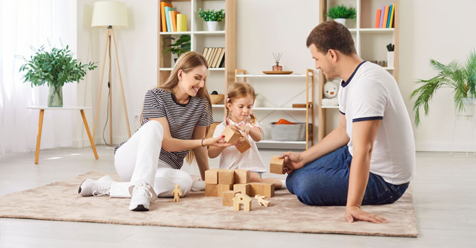 Image showing a joyfull parents plying wooden game with their daughter